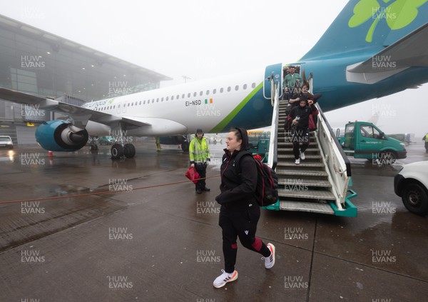 110424 - Wales Women Rugby Travel to Ireland - Abbey Constable disembarks the plane at a wet and windy Cork airport ahead of Wales’ Women’s 6 Nations match against Ireland