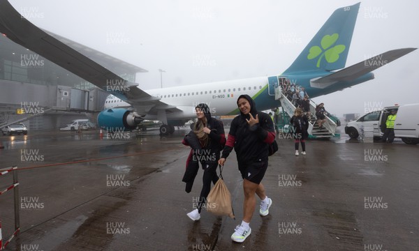 110424 - Wales Women Rugby Travel to Ireland - Hannah Jones and Sisilia Tuipulotu disembark the plane at a wet and windy Cork airport ahead of Wales’ Women’s 6 Nations match against Ireland