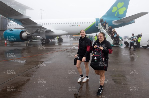 110424 - Wales Women Rugby Travel to Ireland - Carys Cox and Lleucu George disembark the plane at a wet and windy Cork airport ahead of Wales’ Women’s 6 Nations match against Ireland