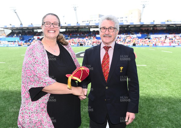 300422 - Wales Women v Italy Women - TikTok Women's Six Nations - Lisa Pritchard-Evans receives her cap from WRU President Gerald Davies