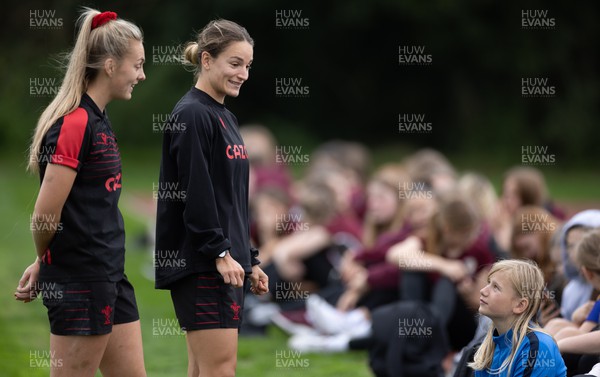 130922 - Wales Women Captains Run - Hannah Jones of Wales and Jazz Joyce of Wales talk to watching schoolchildren during the Captains Run ahead of Wales Women’s World Cup warm up match against England