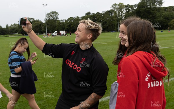 130922 - Wales Women Captains Run - Donna Rose of Wales poses with schoolchildren after they watched the Wales Women’s Captains Run ahead of the Women’s World Cup warm up match against England