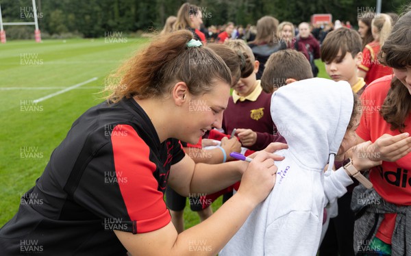 130922 - Wales Women Captains Run - Gwenllian Pyrs of Wales signs autographs for schoolchildren after they watched the Wales Women’s Captains Run ahead of the Women’s World Cup warm up match against England