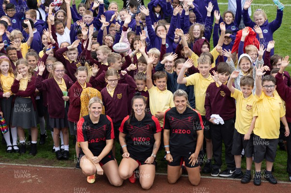 130922 - Wales Women Captains Run - Carys Williams-Morris, Ffion Lewis and Lowri Norkett of Wales with schoolchildren after they watched the Captains Run ahead of the Women’s World Cup warm up match against England