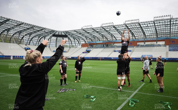 220423 - Wales Women Rugby Captains Run - Kelsey Jones runs through line out throws during Captain’s Run at the Stade des Alpes in Grenoble ahead of the TicTok Women’s 6 Nations match against France