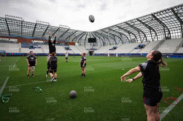 220423 - Wales Women Rugby Captains Run - Kat Evans runs through line out throws during Captain’s Run at the Stade des Alpes in Grenoble ahead of the TicTok Women’s 6 Nations match against France