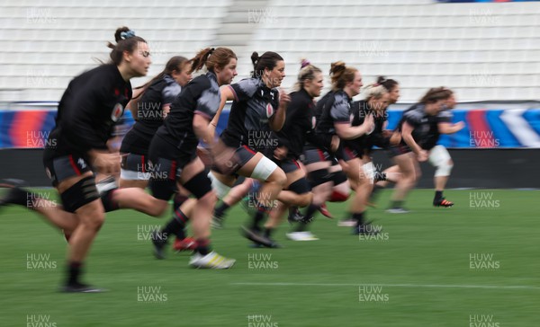 220423 - Wales Women Rugby Captains Run - The Wales Squad warm up during Captain’s Run at the Stade des Alpes in Grenoble ahead of the TicTok Women’s 6 Nations match against France
