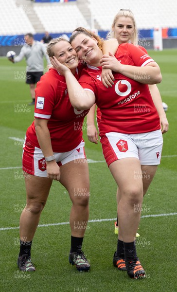 220423 - Wales Women Rugby Captains Run -  Kelsey Jones and Gwenllian Pyrs pose as Carys Williams-Morris photobombs during Captain’s Run at the Stade des Alpes in Grenoble ahead of the TicTok Women’s 6 Nations match against France