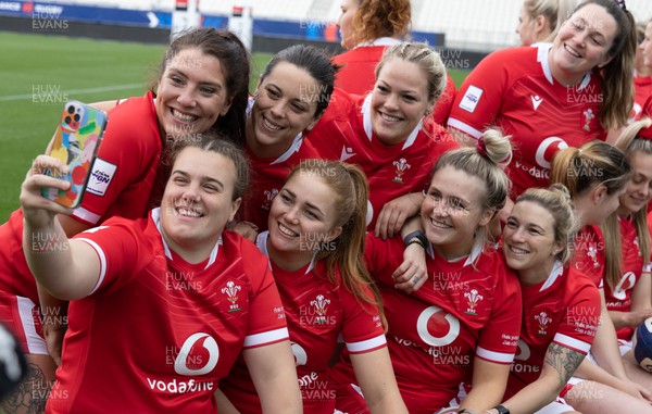 220423 - Wales Women Rugby Captains Run - Left to right, Georgia Evans, Carys Phillips, Sioned Harries, Niamh Terry, Kelsey Jones, Alex Callender, Keira Bevan and Cerys Hale pose for a selfie while waiting for the team photograph at the Stade des Alpes in Grenoble ahead of the TicTok Women’s 6 Nations match against France