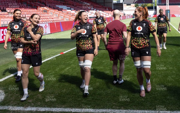 240426 - Wales Women’s Rugby Captain’s Run - Jasmine Joyce and Alisha Joyce share a joke with Georgia Evans during Captain’s Run at Ashton Gate, ahead of the Women’s 6 Nations match against England