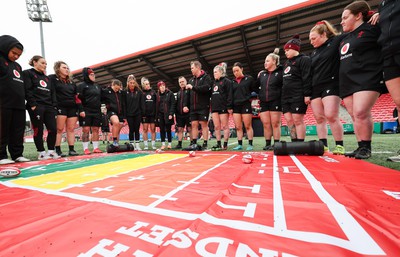 120424 - Wales Women Rugby Walkthrough - Ioan Cunningham, Wales Women head coach, speak to the players during Captain’s Walkthrough and kickers session at Virgin Media Park, Cork, ahead of Wales’ Women’s 6 Nations match against Ireland