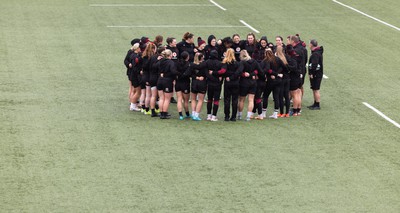 120424 - Wales Women Rugby Walkthrough - The Wales team huddle up during Captain’s Walkthrough and kickers session at Virgin Media Park, Cork, ahead of Wales’ Women’s 6 Nations match against Ireland