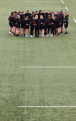 120424 - Wales Women Rugby Walkthrough - The Wales team huddle up during Captain’s Walkthrough and kickers session at Virgin Media Park, Cork, ahead of Wales’ Women’s 6 Nations match against Ireland