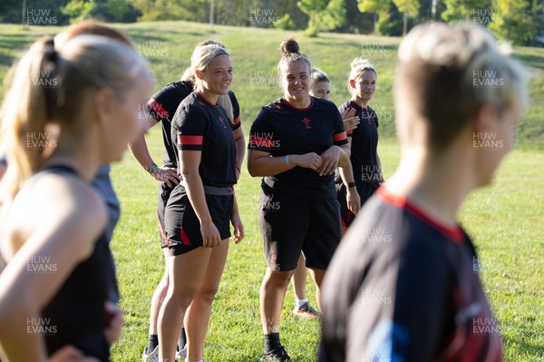 250822 - Wales Women Rugby Community Engagement in Canada - Wales’ Alisha Butchers and Carys Phillips working with Halifax RFC Junior Girls during a training session in Halifax, Canada