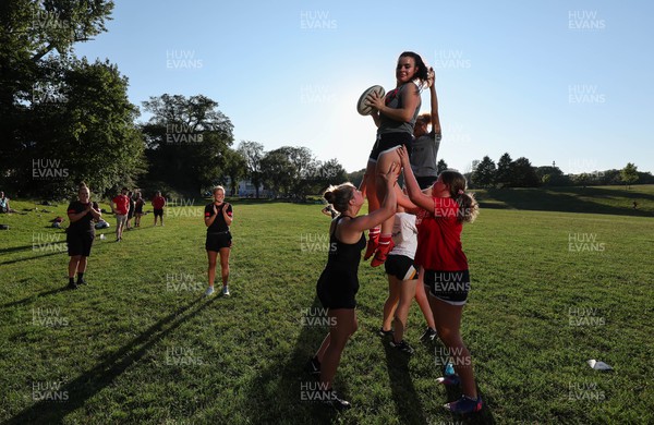 250822 - Wales Women Rugby Community Engagement in Canada - Wales’ Carys Phillips and Alisha Butchers working with Halifax RFC Junior Girls on their line out during a training session in Halifax, Canada