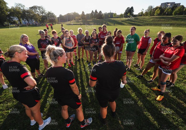 250822 - Wales Women Rugby Community Engagement in Canada - Wales’ Alisha Butchers, Kerin Lake and Carys Phillips chat with Halifax RFC Junior Girls during a training session in Halifax, Canada