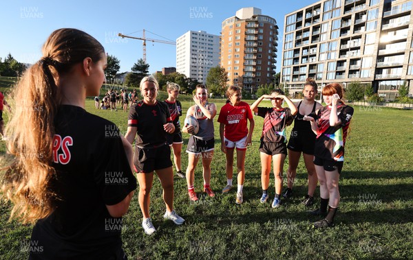 250822 - Wales Women Rugby Community Engagement in Canada - Wales’ Alisha Butchers chats with members of Halifax RFC Junior Girls during a training session in Halifax, Canada