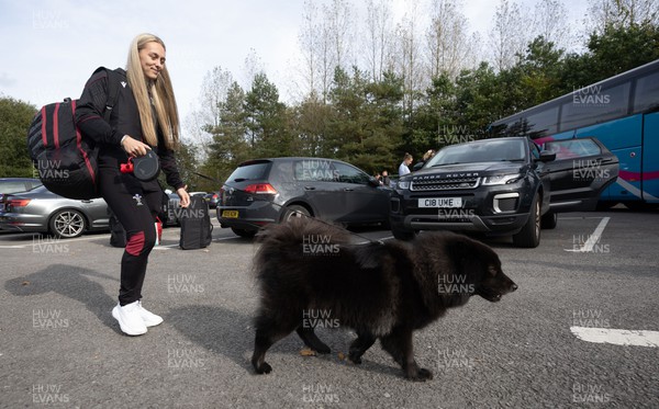 101023 - Wales Women Rugby team depart for WXV1 - Wales captain Hannah Jones is lead to the coach by her dog Luna as she prepares to depart the National Centre of Excellence at the Vale for WXV1 in New Zealand