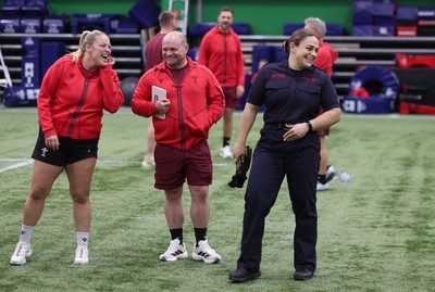 040526 - Wales Women Rugby with South Wales Fire Service - Wales International Squad member and South Wales Fire Service fire fighter Jenni Scoble brings her colleagues from Blue Watch Roath to meet and take part in team building with her Wales team members Jenni Scoble shares a joke with Kelsey Jones and Sean Lynn, Wales Women head coach