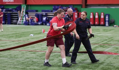 040526 - Wales Women Rugby with South Wales Fire Service - Wales International Squad member and South Wales Fire Service fire fighter Jenni Scoble brings her colleagues from Blue Watch Roath to meet and take part in team building with her Wales team members Jenni Scoble works with Maisie Davies during a team challenge