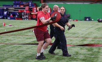 040526 - Wales Women Rugby with South Wales Fire Service - Wales International Squad member and South Wales Fire Service fire fighter Jenni Scoble brings her colleagues from Blue Watch Roath to meet and take part in team building with her Wales team members Jenni Scoble works with Maisie Davies during a team challenge