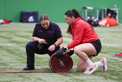 040526 - Wales Women Rugby with South Wales Fire Service - Wales International Squad member and South Wales Fire Service fire fighter Jenni Scoble brings her colleagues from Blue Watch Roath to meet and take part in team building with her Wales team members Jenni Scoble works with Jorja Aiono during a team challenge