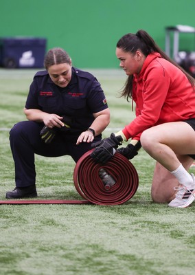 040526 - Wales Women Rugby with South Wales Fire Service - Wales International Squad member and South Wales Fire Service fire fighter Jenni Scoble brings her colleagues from Blue Watch Roath to meet and take part in team building with her Wales team members Jenni Scoble works with Jorja Aiono during a team challenge