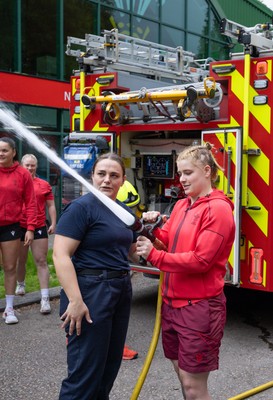 040526 - Wales Women Rugby with South Wales Fire Service - Wales International Squad member and South Wales Fire Service fire fighter Jenni Scoble brings her colleagues from Blue Watch Roath to meet and take part in team building with her Wales team members Jenni Scoble explains the hose operation to Bethan Lewis