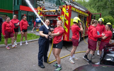 040526 - Wales Women Rugby with South Wales Fire Service - Wales International Squad member and South Wales Fire Service fire fighter Jenni Scoble brings her colleagues from Blue Watch Roath to meet and take part in team building with her Wales team members Jenni Scoble explains the hose operation to Molly Reardon