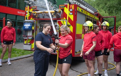 040526 - Wales Women Rugby with South Wales Fire Service - Wales International Squad member and South Wales Fire Service fire fighter Jenni Scoble brings her colleagues from Blue Watch Roath to meet and take part in team building with her Wales team members Jenni Scoble explains the hose operation to Molly Reardon