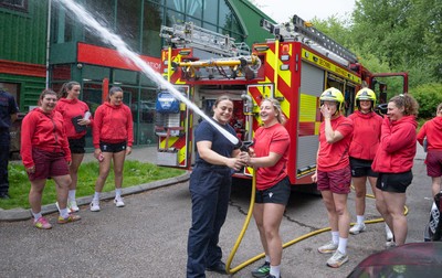 040526 - Wales Women Rugby with South Wales Fire Service - Wales International Squad member and South Wales Fire Service fire fighter Jenni Scoble brings her colleagues from Blue Watch Roath to meet and take part in team building with her Wales team members Jenni Scoble explains the hose operation to Molly Reardon