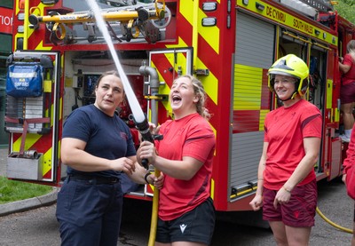 040526 - Wales Women Rugby with South Wales Fire Service - Wales International Squad member and South Wales Fire Service fire fighter Jenni Scoble brings her colleagues from Blue Watch Roath to meet and take part in team building with her Wales team members Jenni Scoble explains the hose operation to Molly Reardon
