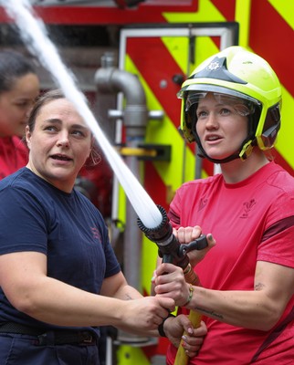 040526 - Wales Women Rugby with South Wales Fire Service - Wales International Squad member and South Wales Fire Service fire fighter Jenni Scoble brings her colleagues from Blue Watch Roath to meet and take part in team building with her Wales team members Jenni Scoble explains the hose operation to Carys Cox