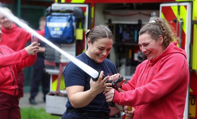 040526 - Wales Women Rugby with South Wales Fire Service - Wales International Squad member and South Wales Fire Service fire fighter Jenni Scoble brings her colleagues from Blue Watch Roath to meet and take part in team building with her Wales team members Jenni Scoble explains the hose operation to Gwenllian Pyrs