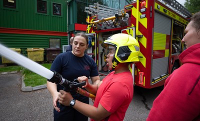 040526 - Wales Women Rugby with South Wales Fire Service - Wales International Squad member and South Wales Fire Service fire fighter Jenni Scoble brings her colleagues from Blue Watch Roath to meet and take part in team building with her Wales team members Jenni Scoble explains the hose operation to Jenna De Vera