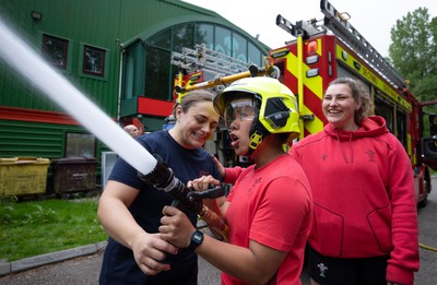 040526 - Wales Women Rugby with South Wales Fire Service - Wales International Squad member and South Wales Fire Service fire fighter Jenni Scoble brings her colleagues from Blue Watch Roath to meet and take part in team building with her Wales team members Jenni Scoble explains the hose operation to Jenna De Vera