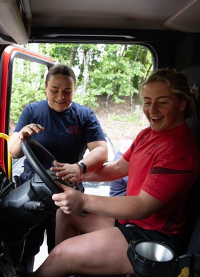 040526 - Wales Women Rugby with South Wales Fire Service - Wales International Squad member and South Wales Fire Service fire fighter Jenni Scoble brings her colleagues from Blue Watch Roath to meet and take part in team building with her Wales team members Molly Reardon gets to take the drivers seat as Jenni Scoble looks on
