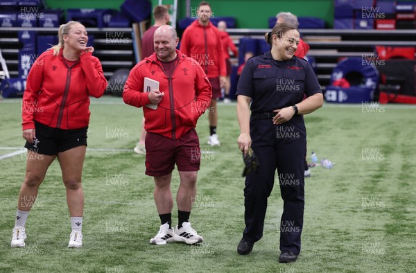 040526 - Wales Women Rugby with South Wales Fire Service - Wales International Squad member and South Wales Fire Service fire fighter Jenni Scoble brings her colleagues from Blue Watch Roath to meet and take part in team building with her Wales team members Jenni Scoble shares a joke with Kelsey Jones and Sean Lynn, Wales Women head coach