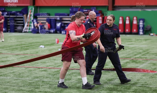 040526 - Wales Women Rugby with South Wales Fire Service - Wales International Squad member and South Wales Fire Service fire fighter Jenni Scoble brings her colleagues from Blue Watch Roath to meet and take part in team building with her Wales team members Jenni Scoble works with Maisie Davies during a team challenge