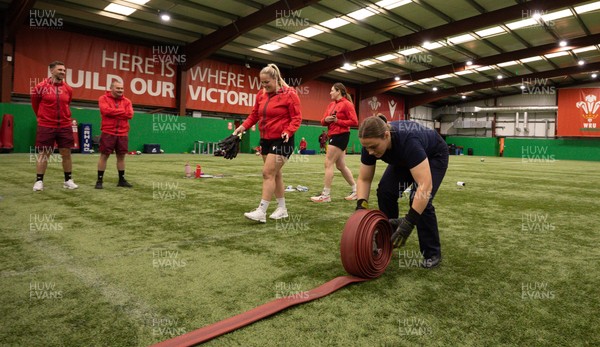 040526 - Wales Women Rugby with South Wales Fire Service - Wales International Squad member and South Wales Fire Service fire fighter Jenni Scoble brings her colleagues from Blue Watch Roath to meet and take part in team building with her Wales team members Jenna De Vera is watched by her team mates