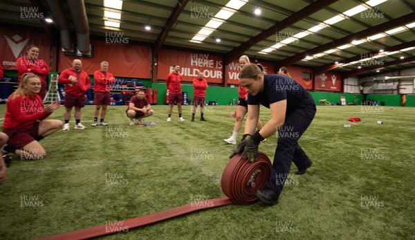 040526 - Wales Women Rugby with South Wales Fire Service - Wales International Squad member and South Wales Fire Service fire fighter Jenni Scoble brings her colleagues from Blue Watch Roath to meet and take part in team building with her Wales team members Jenna De Vera is watched by her team mates