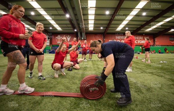 040526 - Wales Women Rugby with South Wales Fire Service - Wales International Squad member and South Wales Fire Service fire fighter Jenni Scoble brings her colleagues from Blue Watch Roath to meet and take part in team building with her Wales team members Jenna De Vera is watched by her team mates