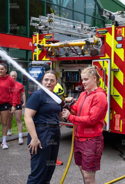 040526 - Wales Women Rugby with South Wales Fire Service - Wales International Squad member and South Wales Fire Service fire fighter Jenni Scoble brings her colleagues from Blue Watch Roath to meet and take part in team building with her Wales team members Jenni Scoble explains the hose operation to Bethan Lewis