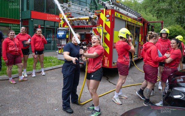 040526 - Wales Women Rugby with South Wales Fire Service - Wales International Squad member and South Wales Fire Service fire fighter Jenni Scoble brings her colleagues from Blue Watch Roath to meet and take part in team building with her Wales team members Jenni Scoble explains the hose operation to Molly Reardon