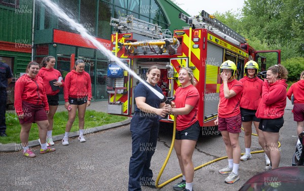 040526 - Wales Women Rugby with South Wales Fire Service - Wales International Squad member and South Wales Fire Service fire fighter Jenni Scoble brings her colleagues from Blue Watch Roath to meet and take part in team building with her Wales team members Jenni Scoble explains the hose operation to Molly Reardon
