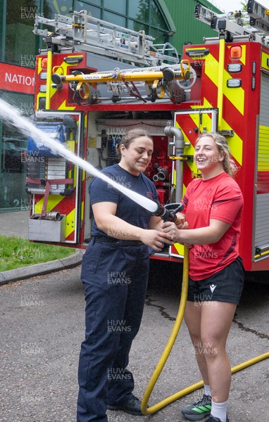 040526 - Wales Women Rugby with South Wales Fire Service - Wales International Squad member and South Wales Fire Service fire fighter Jenni Scoble brings her colleagues from Blue Watch Roath to meet and take part in team building with her Wales team members Jenni Scoble explains the hose operation to Molly Reardon