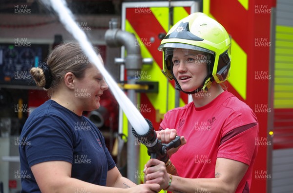 040526 - Wales Women Rugby with South Wales Fire Service - Wales International Squad member and South Wales Fire Service fire fighter Jenni Scoble brings her colleagues from Blue Watch Roath to meet and take part in team building with her Wales team members Jenni Scoble explains the hose operation to Carys Cox