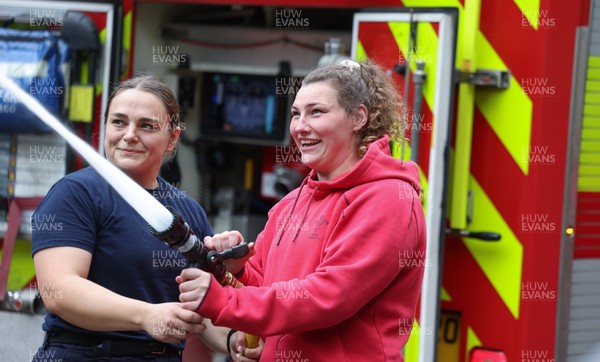 040526 - Wales Women Rugby with South Wales Fire Service - Wales International Squad member and South Wales Fire Service fire fighter Jenni Scoble brings her colleagues from Blue Watch Roath to meet and take part in team building with her Wales team members Jenni Scoble explains the hose operation to Gwenllian Pyrs