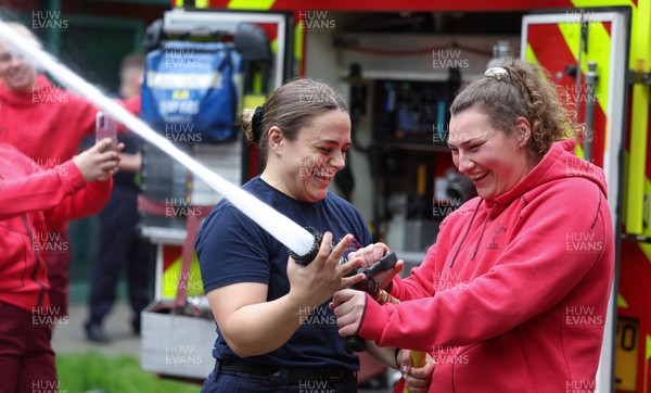 040526 - Wales Women Rugby with South Wales Fire Service - Wales International Squad member and South Wales Fire Service fire fighter Jenni Scoble brings her colleagues from Blue Watch Roath to meet and take part in team building with her Wales team members Jenni Scoble explains the hose operation to Gwenllian Pyrs