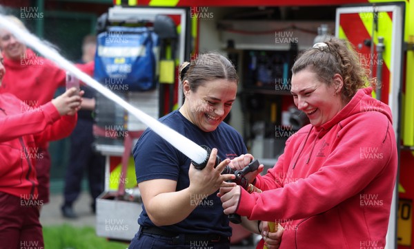 040526 - Wales Women Rugby with South Wales Fire Service - Wales International Squad member and South Wales Fire Service fire fighter Jenni Scoble brings her colleagues from Blue Watch Roath to meet and take part in team building with her Wales team members Jenni Scoble explains the hose operation to Gwenllian Pyrs